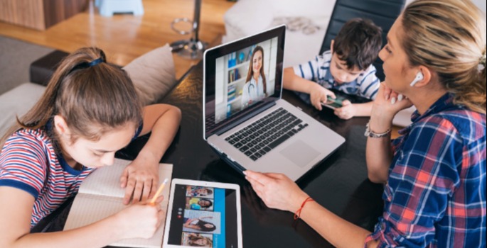 Family working on computers and devices